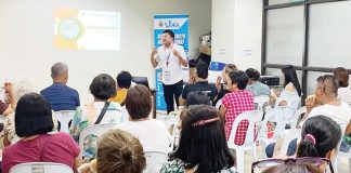 A resource speaker discusses service quality with market vendors during a training session of the Uswag Negosyo Academy at the Local Economic Development and Investment Promotion Office, Iloilo City Hall. The program aims to equip vendors with business skills and grant them additional capital upon completion.