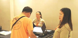 A resident of Barangay Airport, Mandurriao, Iloilo City participates in the final testing and sealing of vote counting machines at Festive Walk Mall on May 5, supervised by members of the Electoral Board ahead of the May 12 elections. AJ PALCULLO/PN