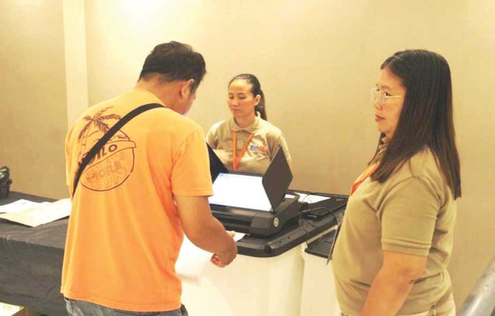 mai_vote_testing_1_resized A resident of Barangay Airport, Mandurriao, Iloilo City participates in the final testing and sealing of vote counting machines at Festive Walk Mall on May 5, supervised by members of the Electoral Board ahead of the May 12 elections. AJ PALCULLO/PN