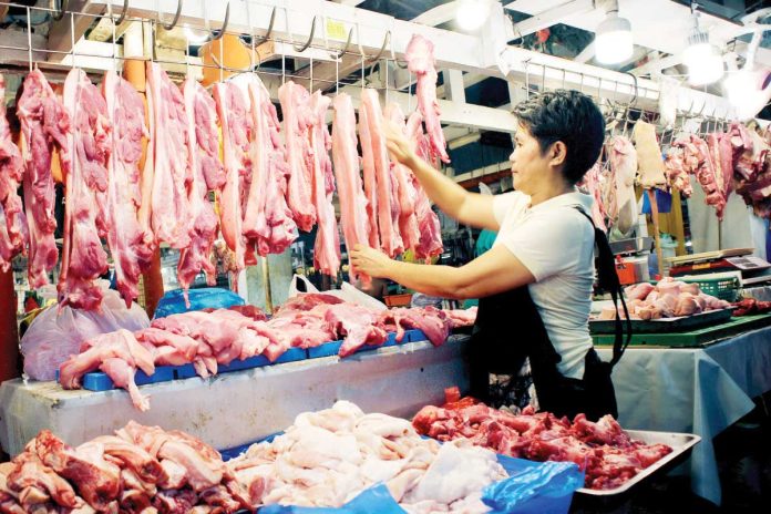 meat_imports_resized A vendor arranges her display of fresh pork at a public market in Davao City. The Philippinesā pork imports in the first quarter of 2025 accounted for 183.19 million kilograms, mostly consisting of pork cuts and offals. PNA PHOTO BY ROBINSON NIĆAL JR.