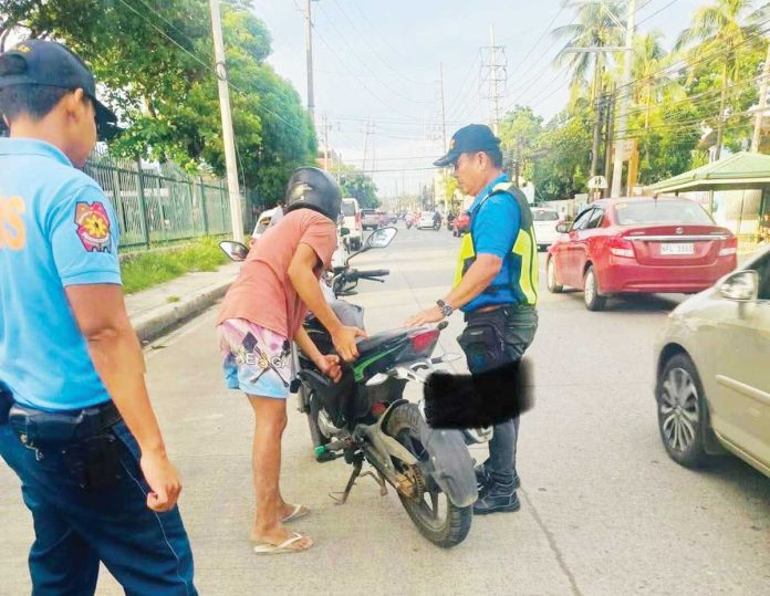 motorcycles-pic Personnel of the Iloilo City Traffic and Transportation Management Office (ICTTMO) flag down a motorcyclist along Huervana St., La Paz district for a traffic violation on May 28, 2025. The ICTTMO has issued citation tickets to a total of 2,363 motorcycle riders from January to May 5, 2025. ILOILO CITY TRAFFIC AND TRANSPORTATION MANAGEMENT OFFICE PHOTO