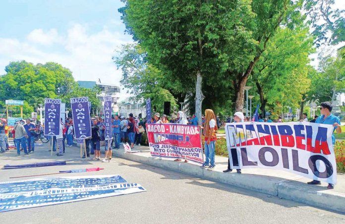 Members of various transport groups under the Panay-Negros United Transport Coalition stage a protest at Jaro Plaza in Iloilo City on May 30 to oppose the phase-out of traditional jeepneys and call for the reinstatement of unconsolidated units. They later marched to the Land Transportation Franchising and Regulatory Board regional office demanding equal rights and registration for all public utility jeepney operators. AJ PALCULLO/PN