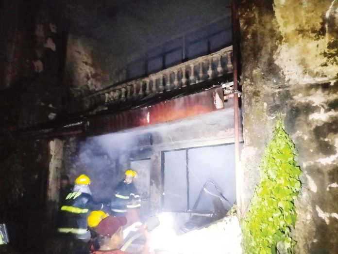 Firefighters help extinguish the fire that hit a house on Thursday night, May 8, 2025, in Barangay Baybay, Roxas City. BASKOG RADYO/FACEBOOK PHOTO