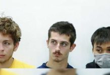 Belgium nationals David Lornoy and Seppe Lodewijckx sit next to Vietnamese national Duh Hung Nyugen who is wearing a mask. The suspects pleaded guilty to smuggling ants in Kenya. REUTERS