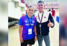 Alfrence Braza, shown here with his coach, took home a silver medal in the men’s 1,500-meter event of the 85th Singapore Open Track and Field Championships. PATAFA