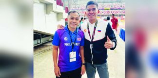 Alfrence Braza, shown here with his coach, took home a silver medal in the men’s 1,500-meter event of the 85th Singapore Open Track and Field Championships. PATAFA