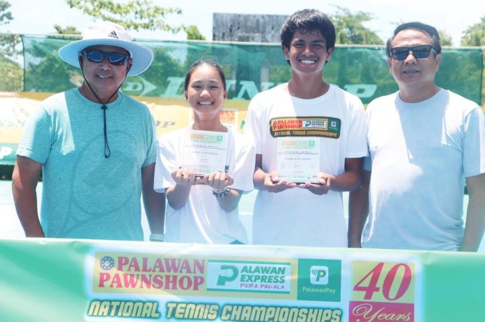 Kathryn Bugna (second from left) flashes a proud smile after pulling off another impressive three-title sweep in Aklan. Joining her are (from left) coach Ronald Martin, boys’ MVP Rizzjun Labindao and Dr. Rizzel Labindao. CONTRIBUTED PHOTO