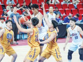 Meralco Bolts center Brandon Bates protects the ball from NLEX Road Warriors’ defenders. PBA PHOTO