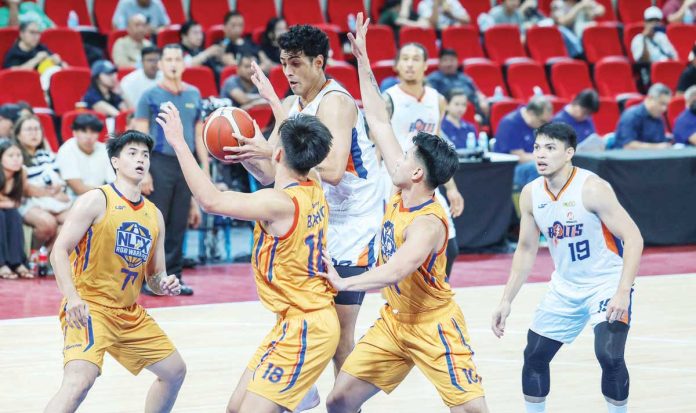 sports_Meralco_resized Meralco Bolts center Brandon Bates protects the ball from NLEX Road Warriors’ defenders. PBA PHOTO