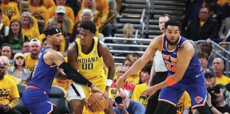 Indiana Pacers guard Bennedict Mathurin (00) drives to the hoop past New York Knicks guard Josh Hart (3) and center Karl-Anthony Towns (32) during the second quarter of game three of the eastern conference finals for the 2025 NBA Playoffs at Gainbridge Fieldhouse. TREVOR RUSZKOWSKI-IMAGN IMAGES