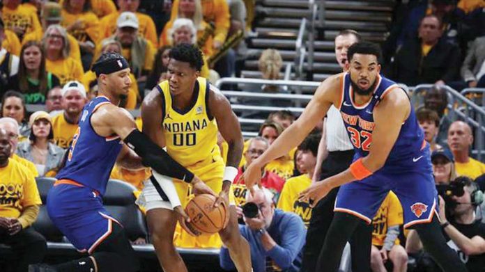 sports_NBA Indiana Pacers guard Bennedict Mathurin (00) drives to the hoop past New York Knicks guard Josh Hart (3) and center Karl-Anthony Towns (32) during the second quarter of game three of the eastern conference finals for the 2025 NBA Playoffs at Gainbridge Fieldhouse. TREVOR RUSZKOWSKI-IMAGN IMAGES