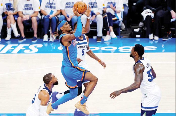sports_NBA Oklahoma City Thunder's Shai Gilgeous-Alexander (2) shoots the ball against Minnesota Timberwolves' Mike Conley (10). PHOTO COURTESY OF ALONZO ADAMS/IMAGN IMAGES