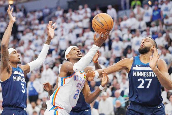sports_NBA_resized Oklahoma City Thunderâs Shai Gilgeous-Alexander goes for a layup against the defense of Minnesota Timberwolvesâ Rudy Gobert. PHOTO COURTESY OF USA TODAY