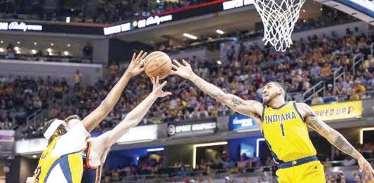 Indiana Pacers’ Myles Turner and Obi Toppin tries to reach the ball for the rebound. PHOTO COURTESY OF INDY STAR