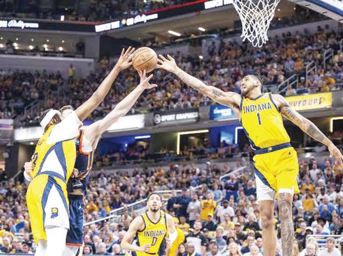 sports_NBA_resized Indiana Pacers’ Myles Turner and Obi Toppin tries to reach the ball for the rebound. PHOTO COURTESY OF INDY STAR