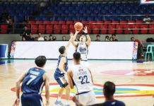 Magnolia Chicken Timplados Hotshots’ Paul Lee shoots against the defense of Meralco Bolts’ Chris Banchero. PBA PHOTO