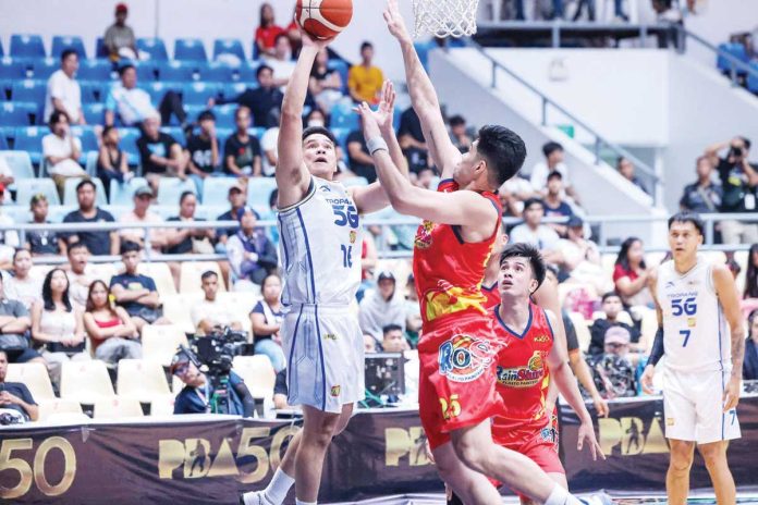 sports_TNT_resized TNT Tropang 5G’s Roger Pogoy attacks the defense of Rain or Shine Elasto Painters’ Leonard Santillan. PBA PHOTO