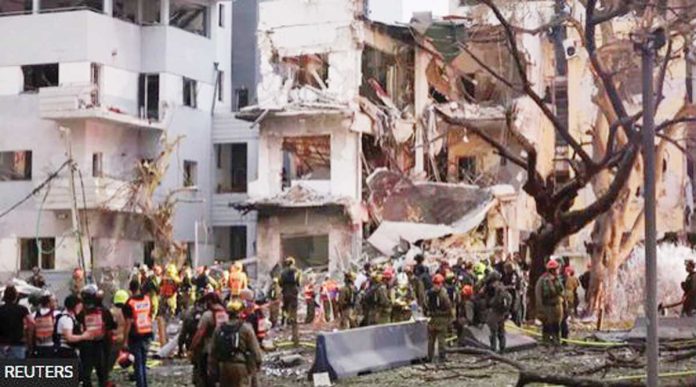 3-Filipinos-copy Missiles launched from Iran damaged these buildings in Tel Aviv, the capital of Israel. REUTERS