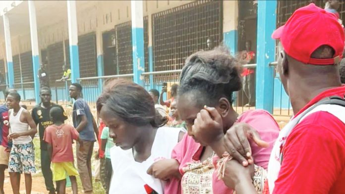 Central Africa Volunteers assist traumatized parents outside Lycée Barthélémy Boganda in Bangui, Central African Republic, after a deadly crush killed 29 pupils and injured over 280 others. The tragedy occurred when a blast at a nearby transformer sparked panic during national exams. ULRICH TOBET