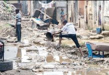Heavy rains in dry season cause havoc in Congo A resident clears water with a bucket amid debris in a residential area affected by flooding following torrential rains in Kinshasa, Congo. AFP VIA GETTY IMAGES