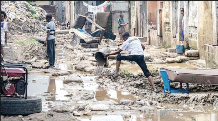 Congo_resized A resident clears water with a bucket amid debris in a residential area affected by flooding following torrential rains in Kinshasa, Congo. AFP VIA GETTY IMAGES