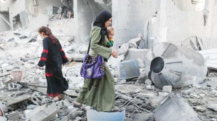 Gaza_copy_resized Palestinians inspect the damage at the site of an Israeli strike on a house in Jabalia, northern Gaza. REUTERS