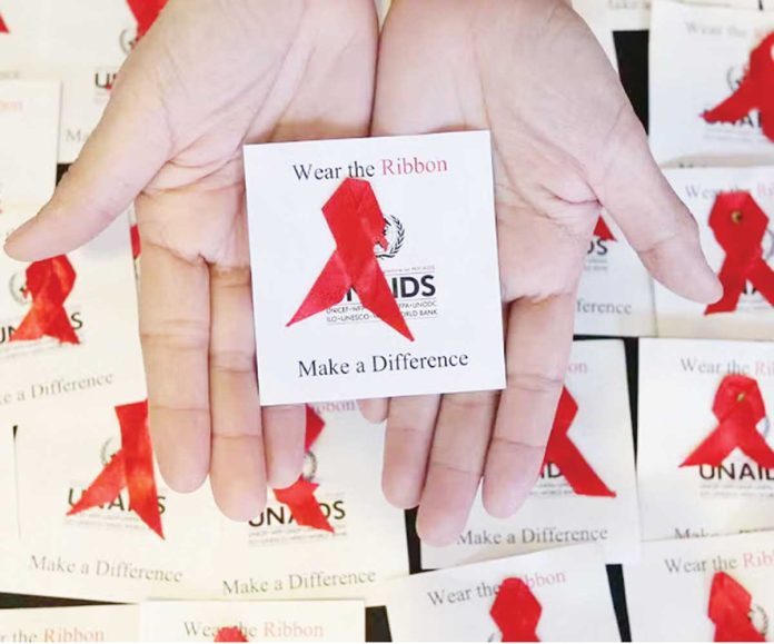 HIV The red ribbon is a recognized symbol for HIV and AIDS awareness used in campaigns to support people living with the disease. MARIANNE BERMUDEZ, PHILIPPINE DAILY INQUIRER