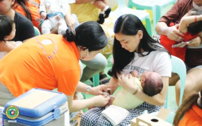 A mother holds her son being immunized against vaccine-preventable diseases in Caloocan City. The Philippines remains among the top countries with the highest number of unvaccinated children, according to the Global Burden of Disease Study Vaccine Coverage Collaborators. DOH