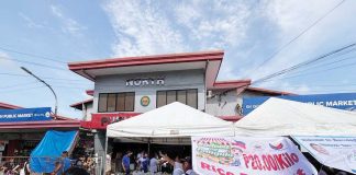 Agriculture Secretary Francisco Tiu Laurel Jr. and Bacolod City officials lead the launch of the P20-per-kilo rice program at Burgos Market on June 5, 2025.
