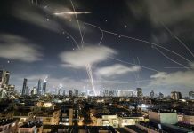 The Israeli Iron Dome air defense system fires to intercept missiles during an Iranian attack over Tel Aviv, Israel. AP