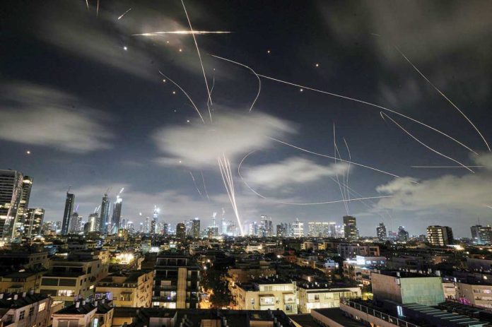 US_copy_resized The Israeli Iron Dome air defense system fires to intercept missiles during an Iranian attack over Tel Aviv, Israel. AP