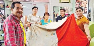 A LIVING RELIC OF HISTORY. This 127-year-old Philippine flag, believed to have been brought by General Emilio Aguinaldo from Hong Kong and hoisted in Libertad, Antique during the 1898 revolution, is now being proposed for declaration as a national treasure. ERROL SANTILLAN PHOTO