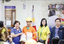 Department of Labor and Employment - Region 6 assistant regional director Melissa Navarra (second from left) and Department of Agriculture - Western Visayas OIC-Regional Technical Director Maria Teresa Solis (second from right) lead the ceremonial distribution of rice to a minimum wage earner during the official launch of the “Benteng Bigas Meron Na!” P20/kilo rice project on June 13 at the National Food Authority compound in Jaro, Iloilo City. Photo from DA-6 Facebook