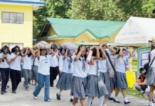 Students of Tigbauan National High School cover their heads with bags and books as they evacuate to safety during the simulated magnitude 7.2 earthquake, held under the 2nd Quarter Nationwide Simultaneous Earthquake Drill in Tigbauan, Iloilo. PHOTO FROM CIVIL DEFENSE WESTERN VISAYAS FACEBOOK