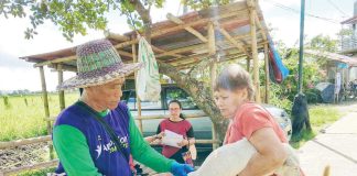 A resident of Barangay Ginalinan Nuevo in Dingle, Iloilo holds her dog as a local government-hired vaccinator administers an anti-rabies shot during a mass vaccination drive. The initiative is part of the province-wide campaign to protect both animals and humans from rabies. PHOTO COURTESY OF FITS OMA DINGLE VIA DR. DAREL TABUADA/FACEBOOK