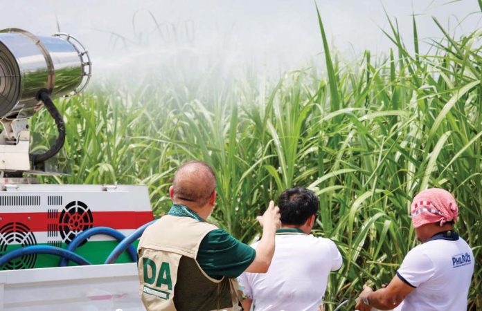 Agriculture Secretary Francisco Tiu Laurel Jr. observes the Department of Agriculture’s Mobile Disinfection Unit in action during a pesticide spraying operation in Bacolod City on June 5. The activity is part of intensified efforts to combat the Red-Striped Soft Scale Insect infestation in Negros Occidental sugarcane farms—an outbreak that has since spread to nearby Panay Island. DA-6 PHOTO