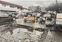 A partially excavated portion of the road in front of a gasoline station along East Timawa, Molo, Iloilo City is left idle and cordoned off after the city government issued a cease-and-desist order against the Department of Public Works and Highways due to lack of permits and proper coordination.