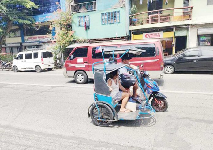 mai-trike2 Unregistered e-trikes continue to operate along the busy roads of Barangay Burgos-Mabini in La Paz district, Iloilo City — just a few meters away from a university and the district plaza — despite the city government's intensified crackdown on colorum units and implementation of the new Tricycle and E-Trike Route Plan. AJ PALCULLO/PN