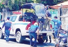 Traffic enforcers load an unregistered e-trike onto a government vehicle during the first day of the crackdown on colorum tricycles in Barangay South Baluarte, Molo, Iloilo City. ILOILO CITY GOVERNMENT PHOTO