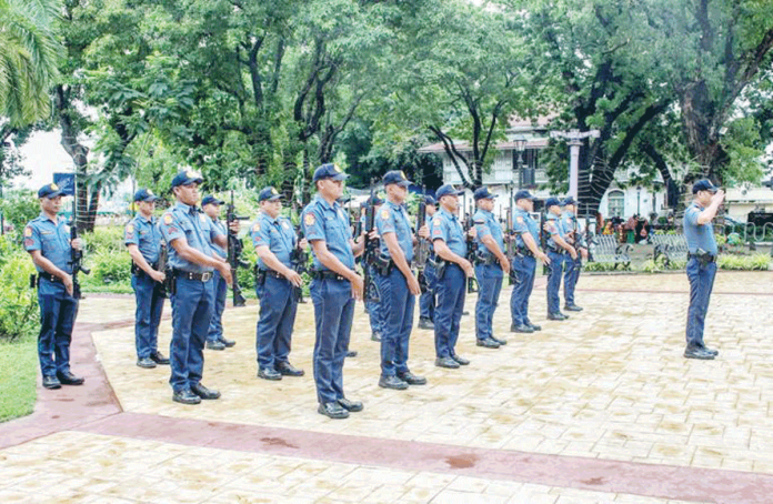 Police officers of the Iloilo City Police Office (ICPO) stand in formation at Plaza Libertad during the 127th Independence Day celebration. The ICPO is now reinforcing its wellness and fitness programs after 98 of its personnel were recently classified as obese. ICPO PHOTO