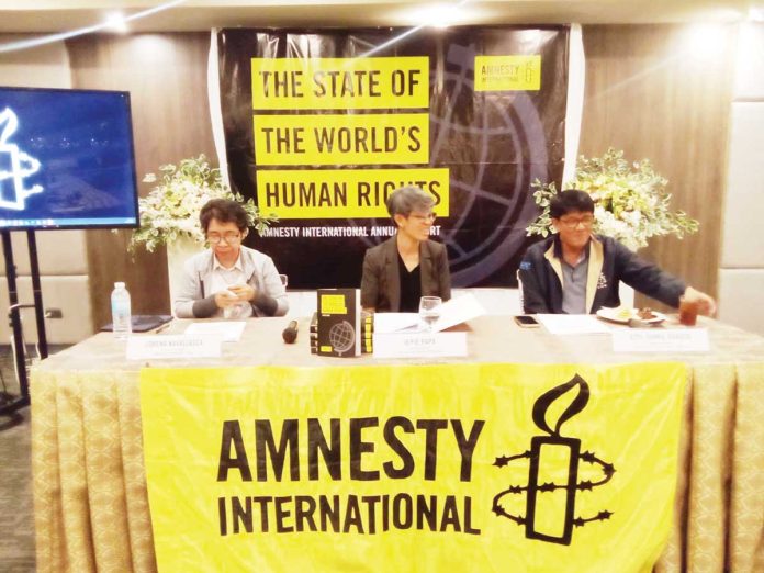 neljoy-climate-human-rights-1 Regional Director Jonnie Dabuco (right) of the Commission on Human Rights – Western Visayas, with Amnesty International Philippines representatives Jepie Papa (left) and Lorena Navallasca (center), underscores the need to view climate change as a human rights issue during a press briefing on the “State of the World’s Human Rights” in Iloilo City. AJ PALCULLO/PN