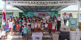 Learners and teachers of Tubigan Elementary School in Barangay Talauguis, Zarraga, Iloilo pose with school supplies and equipment donated through the Brigada Eskwela initiative, as part of the Iloilo provincial government’s support to improve learning conditions in remote communities. CAPITOL PHOTO