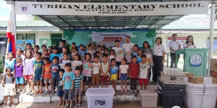 Learners and teachers of Tubigan Elementary School in Barangay Talauguis, Zarraga, Iloilo pose with school supplies and equipment donated through the Brigada Eskwela initiative, as part of the Iloilo provincial government’s support to improve learning conditions in remote communities. CAPITOL PHOTO