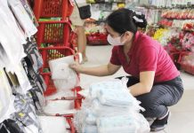 A vendor arranges stacks of face masks in a downtown Iloilo City store as demand surges amid public concern over confirmed mpox cases. Retailers report higher demand but dwindling stocks despite government advisories that mask-wearing is not a primary preventive measure against mpox. NELJOY N. GALIGAO /PN