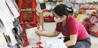 A vendor arranges stacks of face masks in a downtown Iloilo City store as demand surges amid public concern over confirmed mpox cases. Retailers report higher demand but dwindling stocks despite government advisories that mask-wearing is not a primary preventive measure against mpox. NELJOY N. GALIGAO /PN