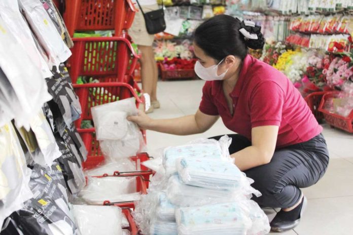 neljoy_face_masks_resized A vendor arranges stacks of face masks in a downtown Iloilo City store as demand surges amid public concern over confirmed mpox cases. Retailers report higher demand but dwindling stocks despite government advisories that mask-wearing is not a primary preventive measure against mpox. NELJOY N. GALIGAO /PN