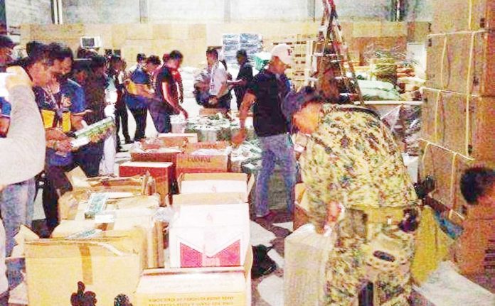 smuggled-cigs Authorities arrested two persons and confiscated over P5 million worth of smuggled cigarettes during an operation in Fullway Industrial Park, Barangay Tacas, Jaro, Iloilo City, on June 18, 2025. REGIONAL MARITIME UNIT 6 PHOTO