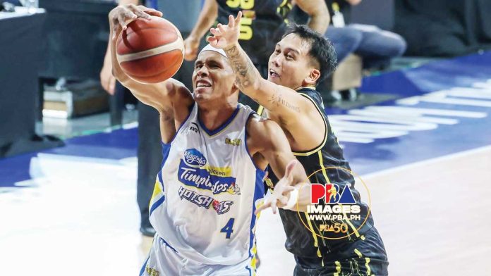 sports-Reavis Magnolia Chicken Timplados Hotshots’ Rafi Reavis battles TNT Tropang 5G's John Paul Erram for the rebound. PBA IMAGES