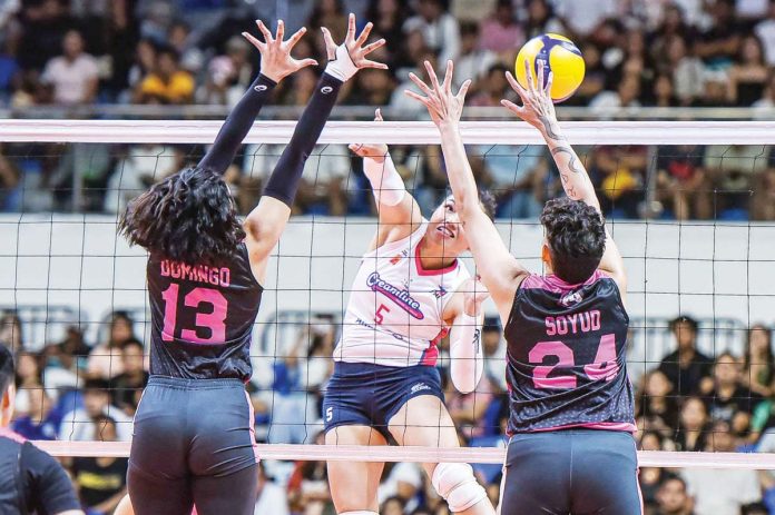 sports_Cool_resized Creamline Cool Smashers' Sheena Toring scores against the defense of Akari Power Chargers' Celine Domingo and Christine Joy Soyud. PVL PHOTO