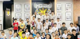 Young participants pose with jiujitsu instructors in this file photo. At a gym, they were introduced to basic grappling techniques and the values of discipline and self-defense. CONTRIBUTED PHOTO